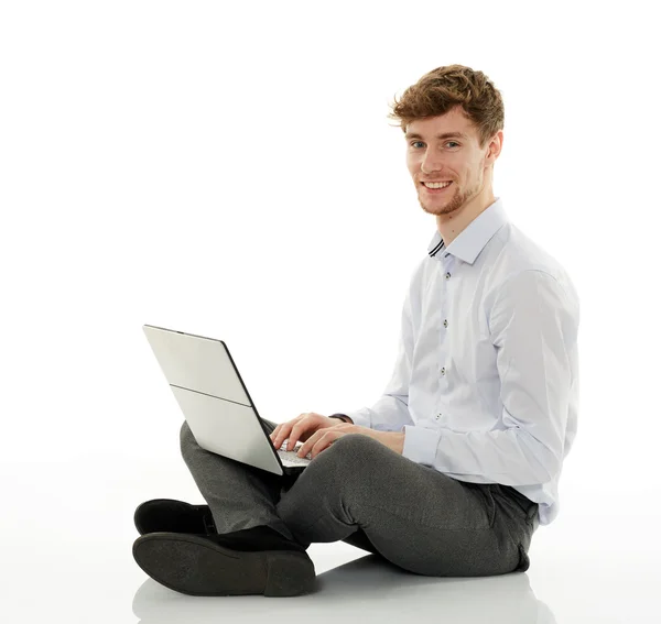 Empresário com laptop no fundo branco — Fotografia de Stock