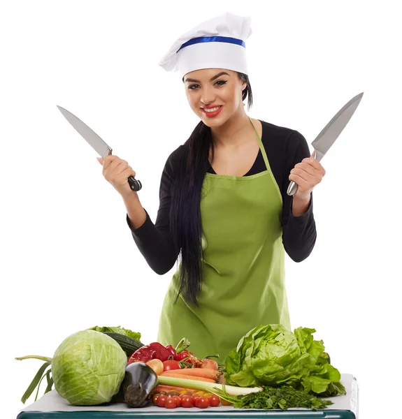 Happy cook with a table of vegetables — Stock Photo, Image