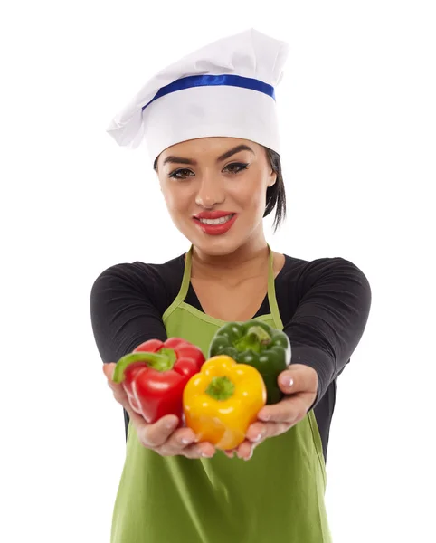Lady cook offering peppers — Stock Photo, Image