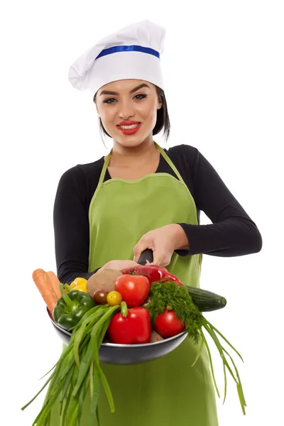 Young latin cook lady with vegetables in frying pan Royalty Free Stock Images