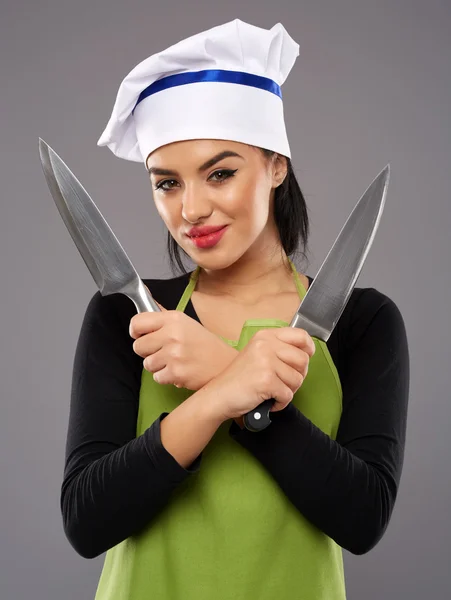 Woman holding knives — Stock Photo, Image