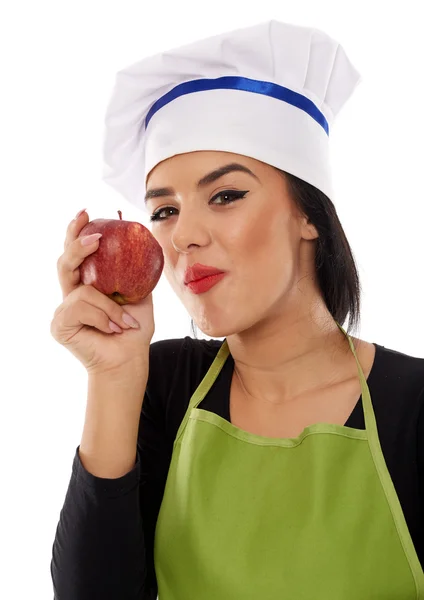 Vrouw chef-kok eten rode appel — Stockfoto