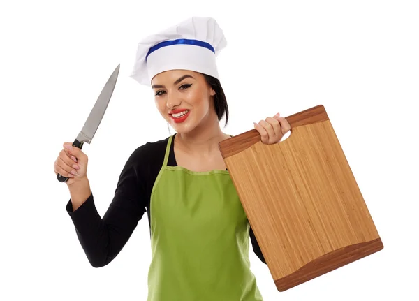 Woman chef holding wooden board and knife — Stock Photo, Image