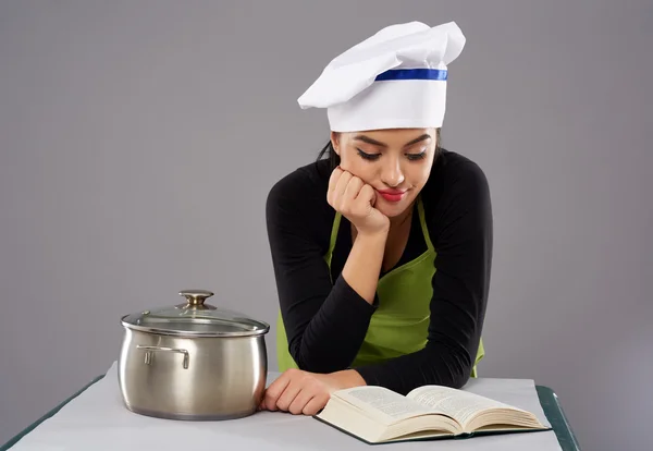 Woman chef reading recipe — Stock Photo, Image