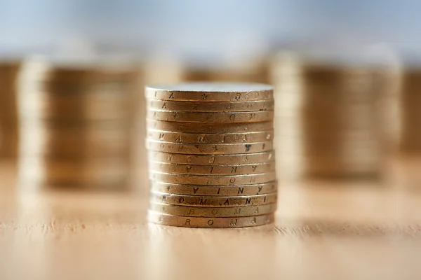 Stacks of coins on wooden table — Stock Photo, Image