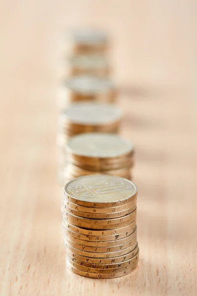 Stacks of coins on wooden table — Stock Photo, Image