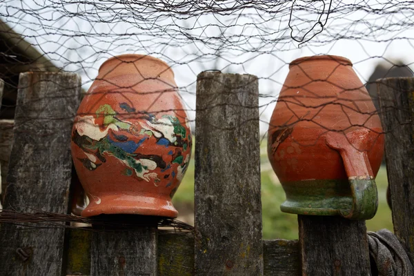 Ceramic pots on the fence — Stock Photo, Image