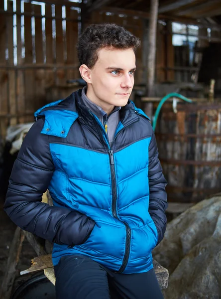 Handsome teenager in barn — Stock Photo, Image