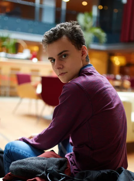 Teenage boy in a restaurant posing — Stock Photo, Image