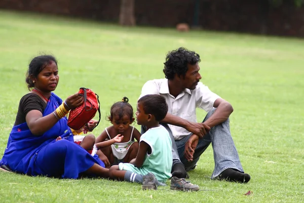 Asian familly relaxing on the grass — Stock Photo, Image