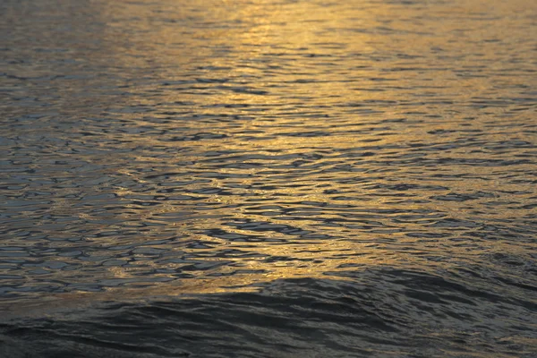 Ocean water surface with calm waves on sunset — Stock Photo, Image