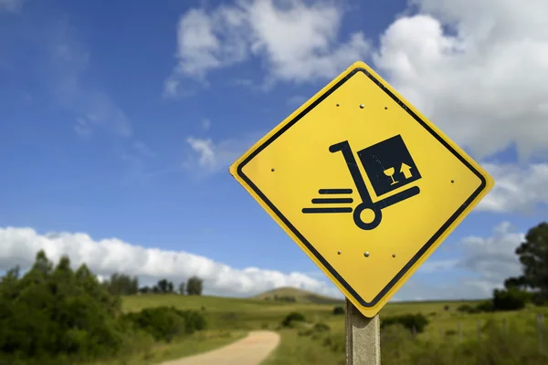 Shipping concept delivery box cart on road sign — Stock Photo, Image