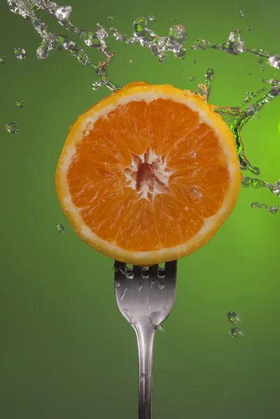 Orange fruit half fork green health concept water — Stockfoto