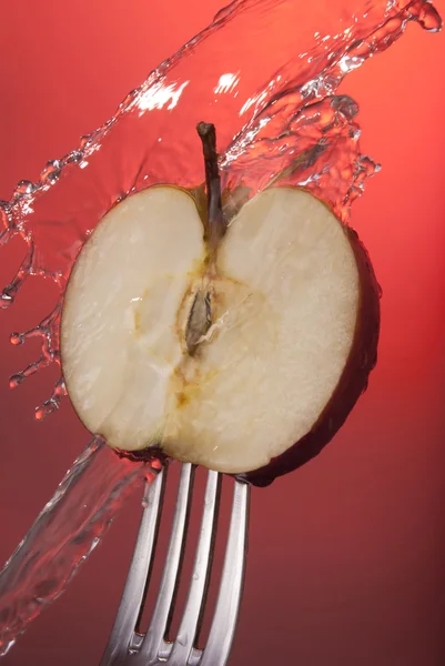 Red apple cut half fork background health water — Stock Photo, Image