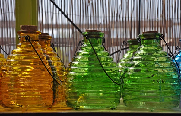 Green and orange glass bottles — Stock Photo, Image