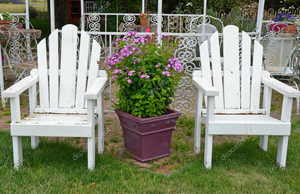 Two old white garden chairs
