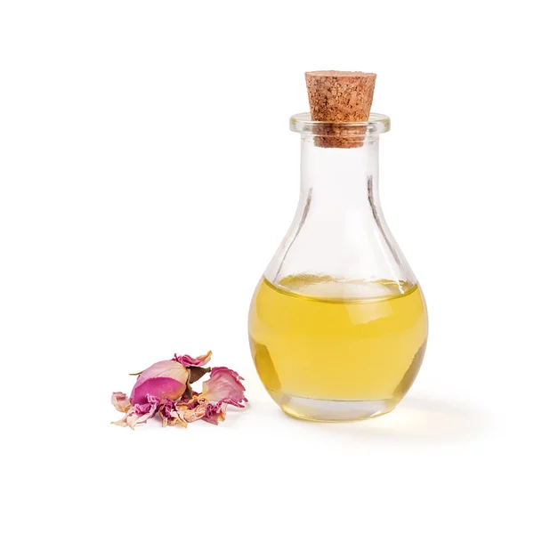 Rose flower petals and buds with aromatherapy essential oil glass bottle — Stock Photo, Image