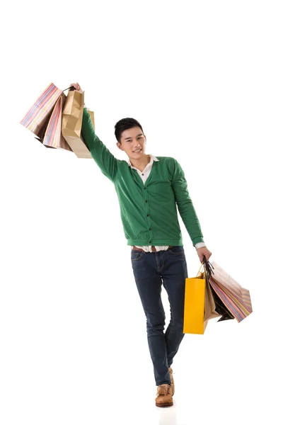 Asian young man holding shopping bags — Stock Photo, Image