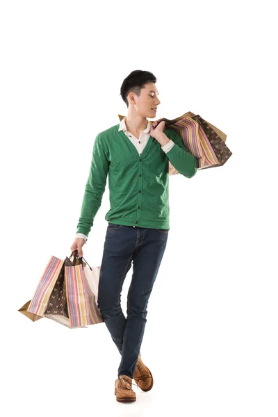 Asian young man holding shopping bags — Stock Photo, Image