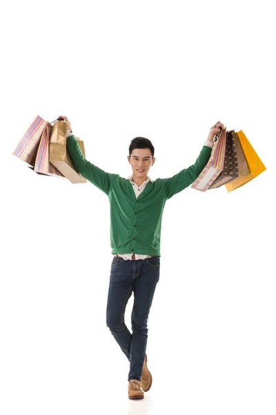 Asian young man holding shopping bags — Stock Photo, Image