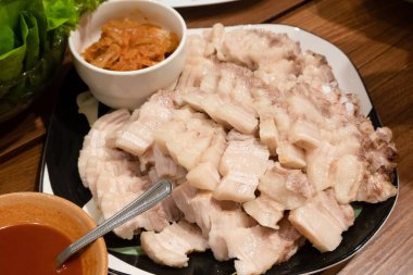 boiled pork belly with garlic sauce in a plate