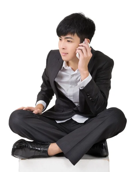 Asian business man take a call and sit on ground. — Stock Photo, Image