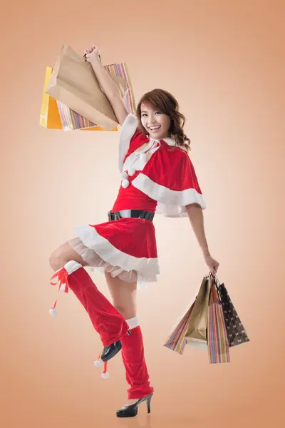Asian Christmas girl hold shopping bags Royalty Free Stock Images