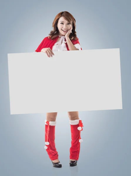 Christmas girl holding a blank board — Stock Photo, Image
