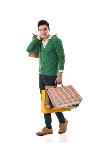 Asian young man holding shopping bags — Stock Photo, Image