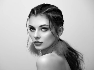 Mükemmel makyajlı esmer kız. Kıvırcık saçlı güzel bir model kadın. Bakım ve güzellik ürünleri. Saçları örgülü bir kadın. Mücevherleri olan bir model. Siyah beyaz fotoğraf