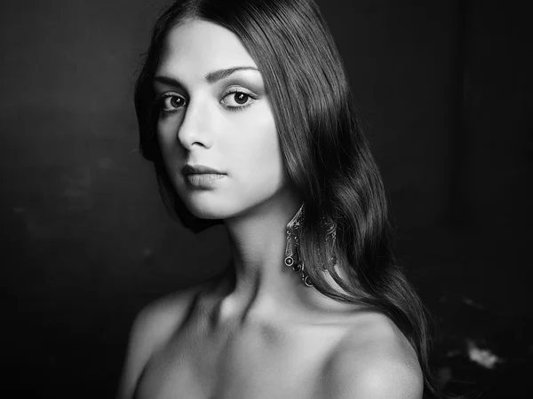 Portrait of beautiful young woman with earring — Stock Photo, Image