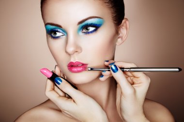 Makeup artist applies lipstick clipart