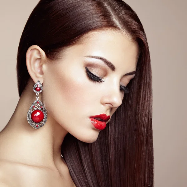 Portrait of beautiful brunette woman with earring — Stock Photo, Image