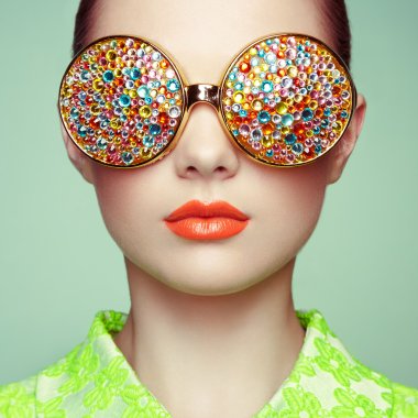 Portrait of beautiful young woman with colored glasses clipart