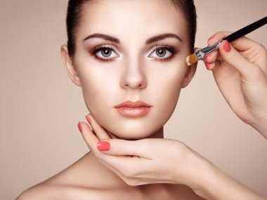 Makeup artist applies skintone clipart