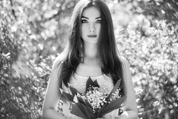 Portrait of beautiful young woman with lily of the valley — Stock Photo, Image