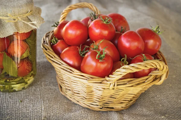 Still life of a basket of tomatoes on canvas