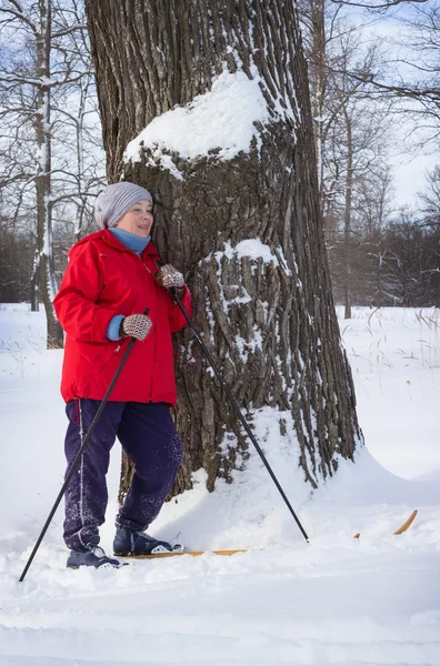 Woman retirement age, walking in winter forest — Stock Photo, Image