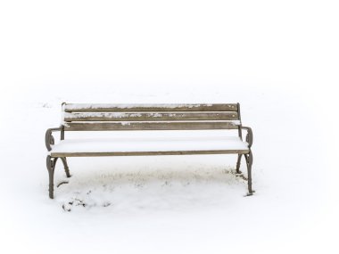 Bench in a snowy winter senery clipart