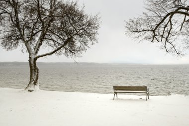 Bench in a snowy winter senery clipart