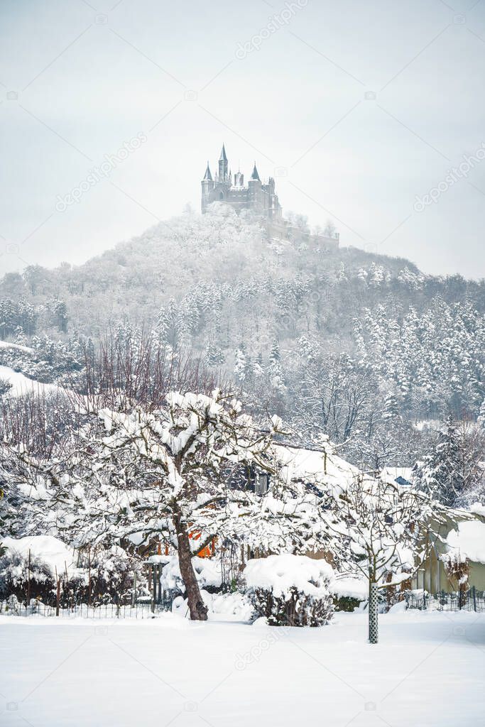 The Castle Hohenzollern in Germany by snowy winter.