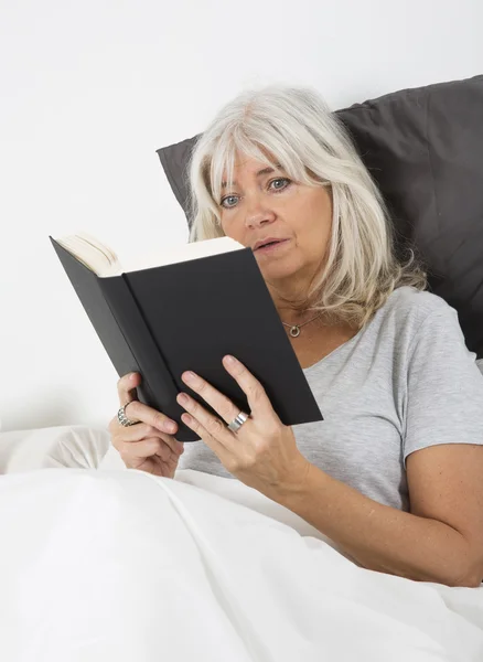 Leyendo un libro que muerde las uñas —  Fotos de Stock