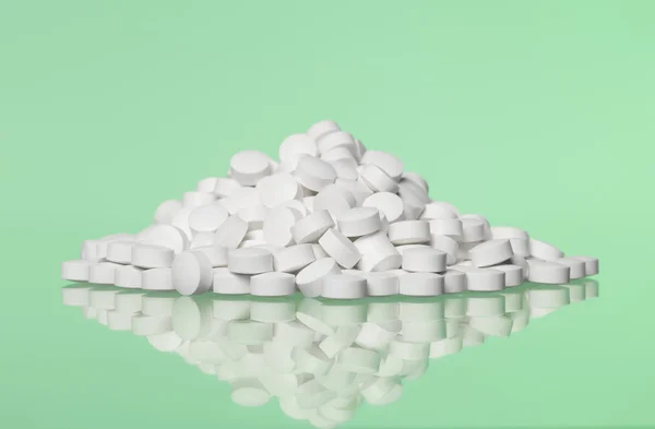 Stack of pills towards green background — Stock Photo, Image