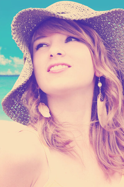 Woman with hat at the beach-color filters