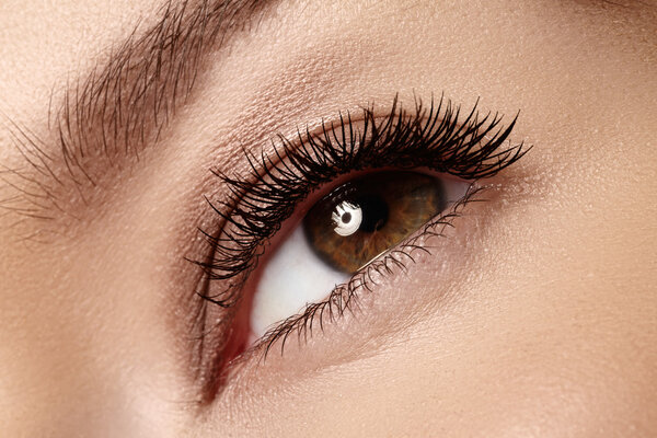 Macro shot of woman's beautiful eye with extremely long eyelashes. Sexy view, sensual look