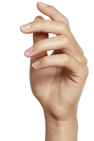 Close-up de mãos de mulher com manicure sobre um fundo branco — Fotografia de Stock