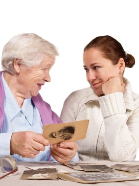 mother with daughter looking photos