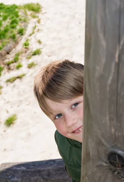 Boy peeking at playground — Stock Photo, Image