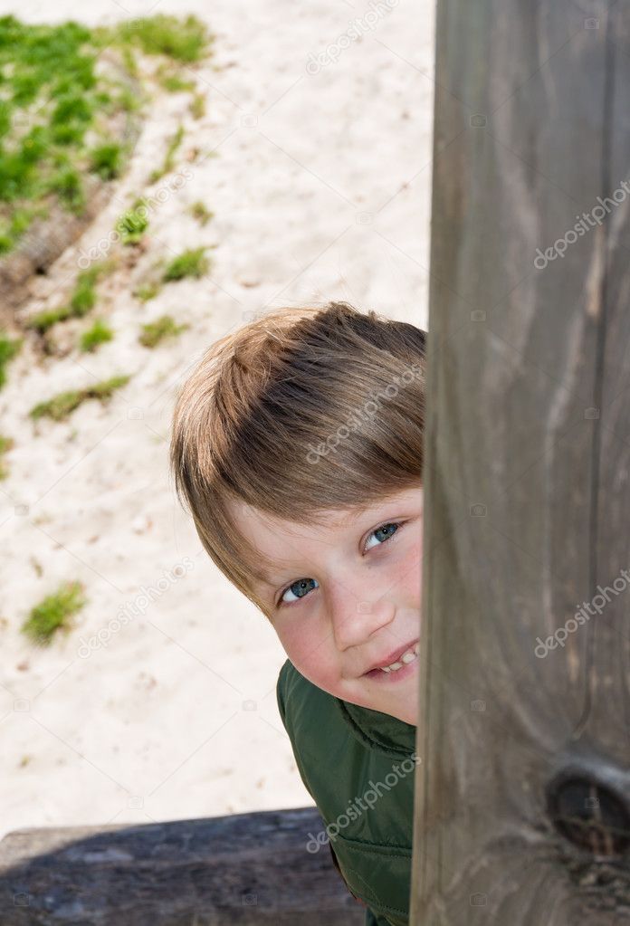 boy peeking at playground