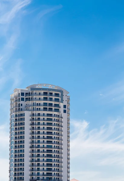 Белая башня Кондо под голубым небом — стоковое фото
